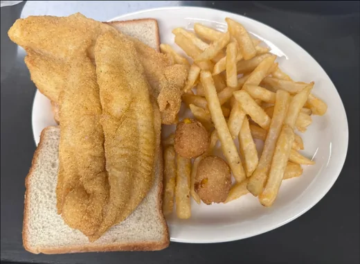 Hand-breaded catfish fillets with fries and hush puppies